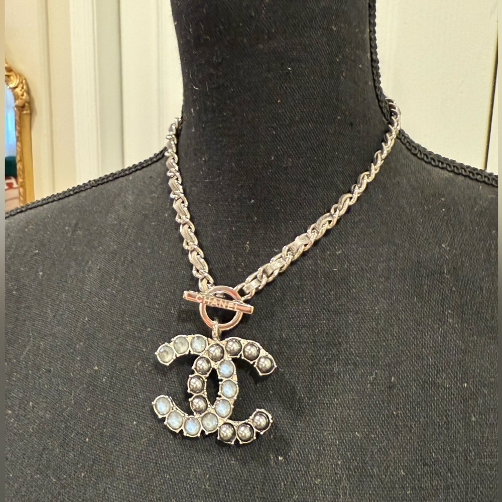 CHANEL Silver Necklace with Crystal Logo Pendant